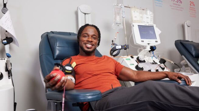 Smiling blood donor giving blood at New York Blood Center